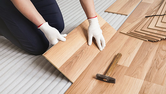 man installing hardwood flooring